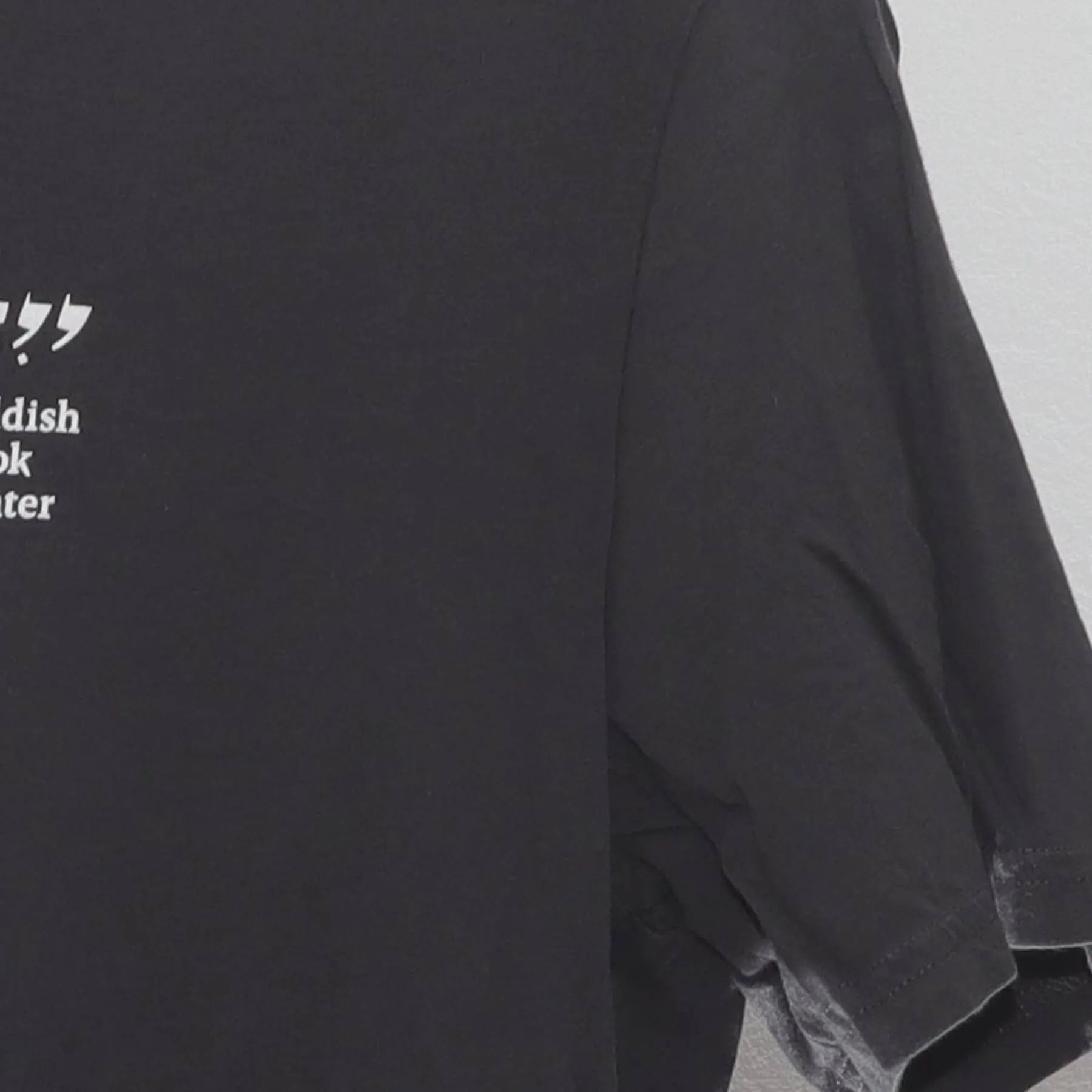 Right sleeve detail of Vintage Yiddish Book Center Goat Graphic T-Shirt Charcoal Gray