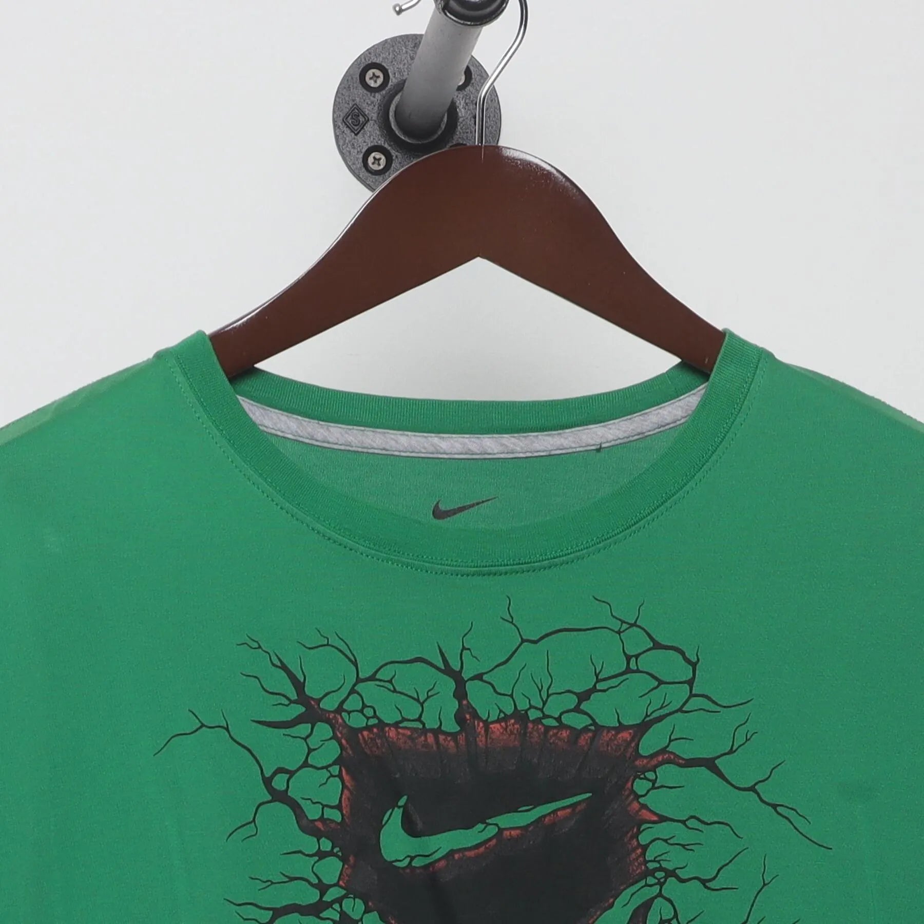 Collar and tag of Vintage Nike Dri-Fit Green Graphic T-Shirt Cracked Shield Swoosh Logo