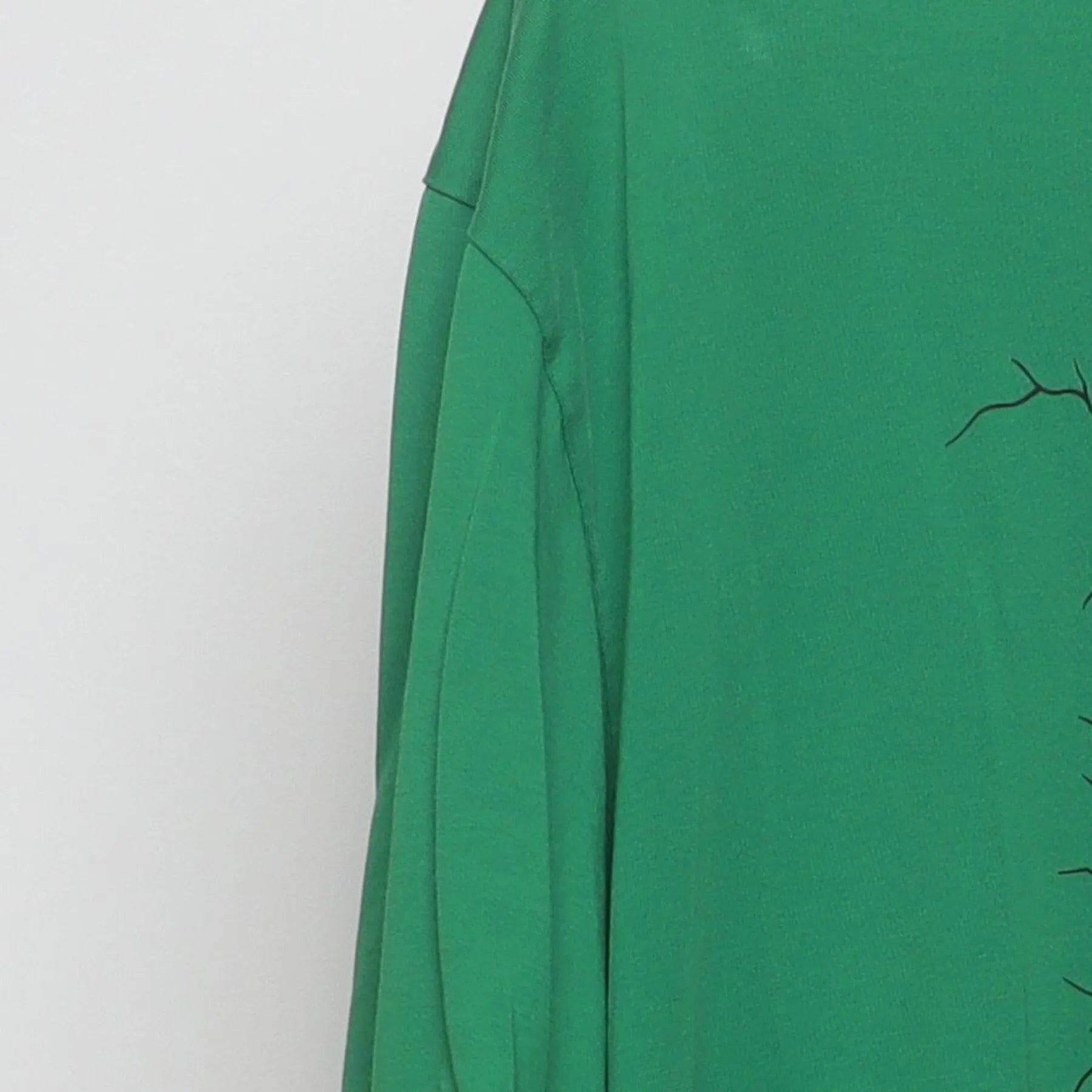 Left sleeve detail of Vintage Nike Dri-Fit Green Graphic T-Shirt Cracked Shield Swoosh Logo