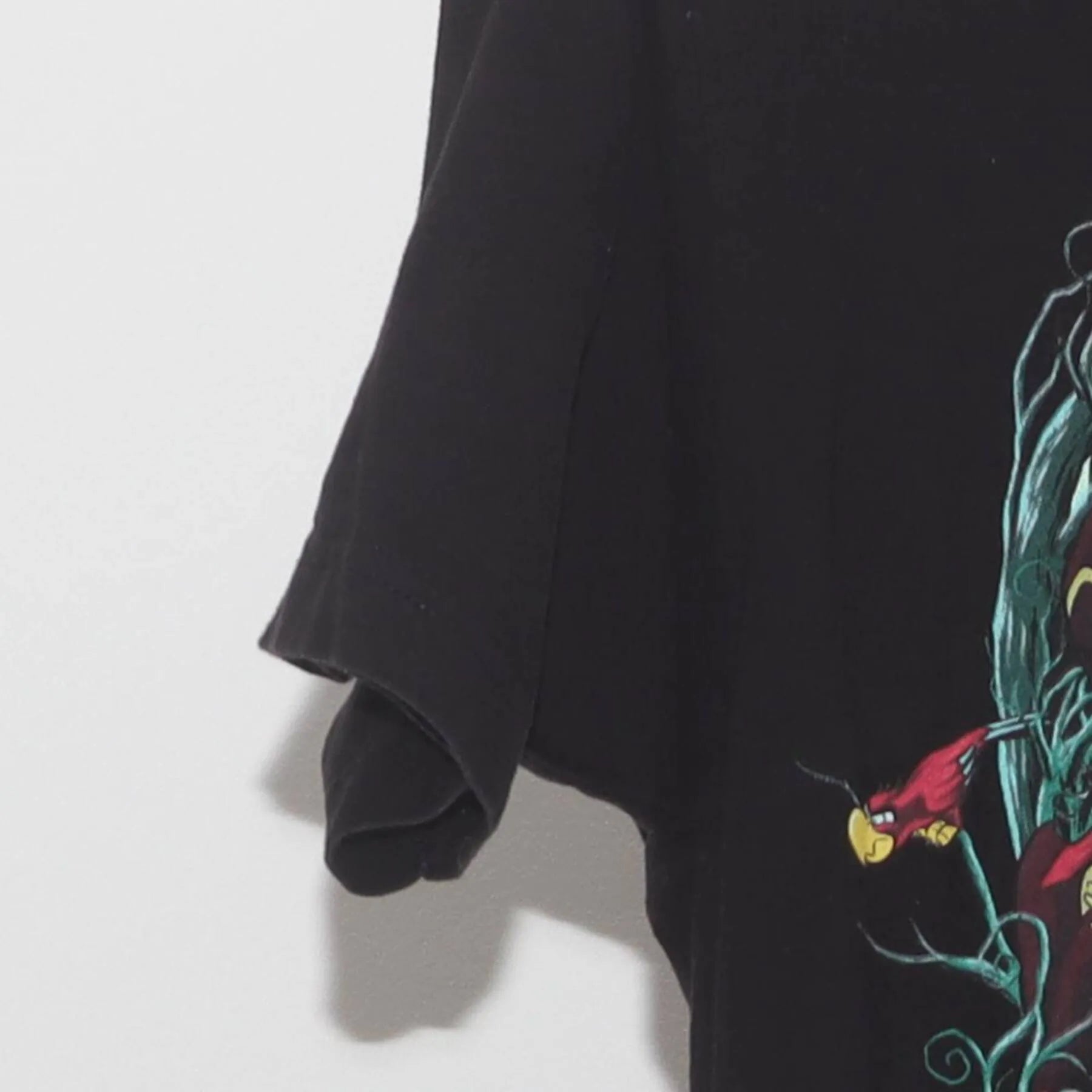 Close-up of the Left sleeve on the Vintage Y2K Disney "Villains Skull" T-Shirt - XS