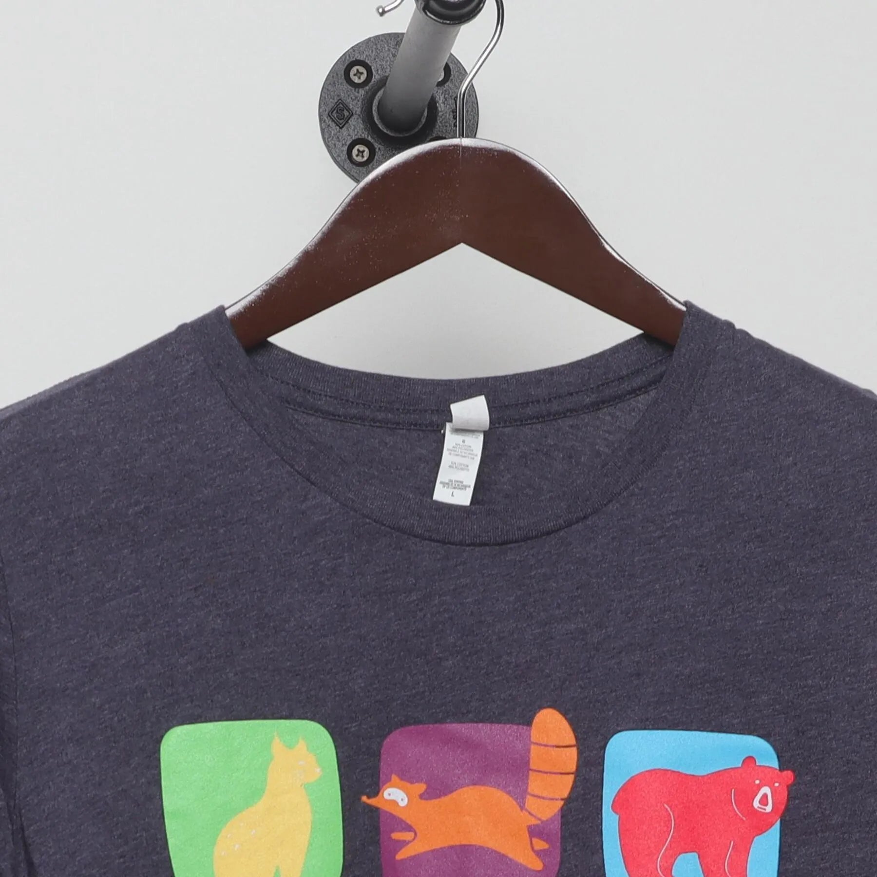 Close-up of the collar and tag on the Vintage 2010s Phoenix Children's "Colorful Animals Grid" T-Shirt - M