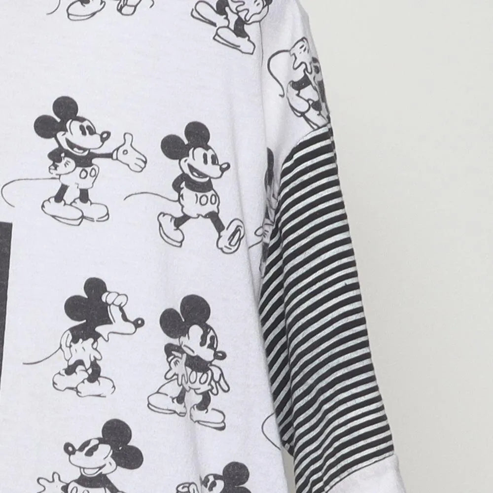 Close-up of the sleeve on the Vintage 1990s Disney "Mickey Mouse All-Over Print" T-Shirt - L