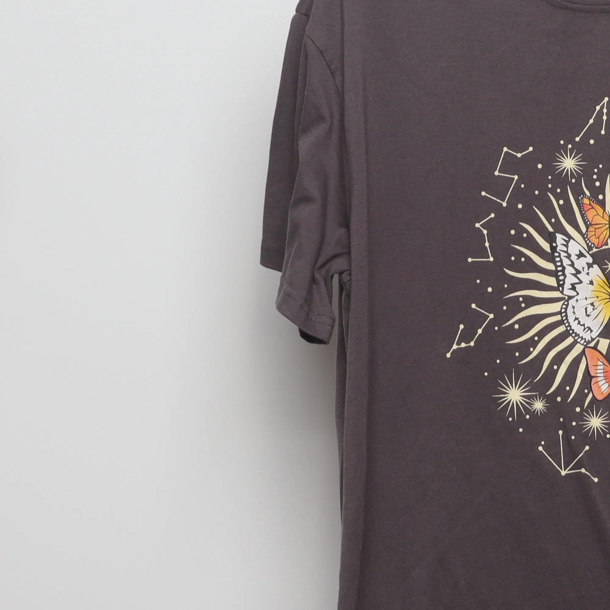 Close-up of the sleeve on the Vintage 2000s Celestial Butterfly Graphic Tee M