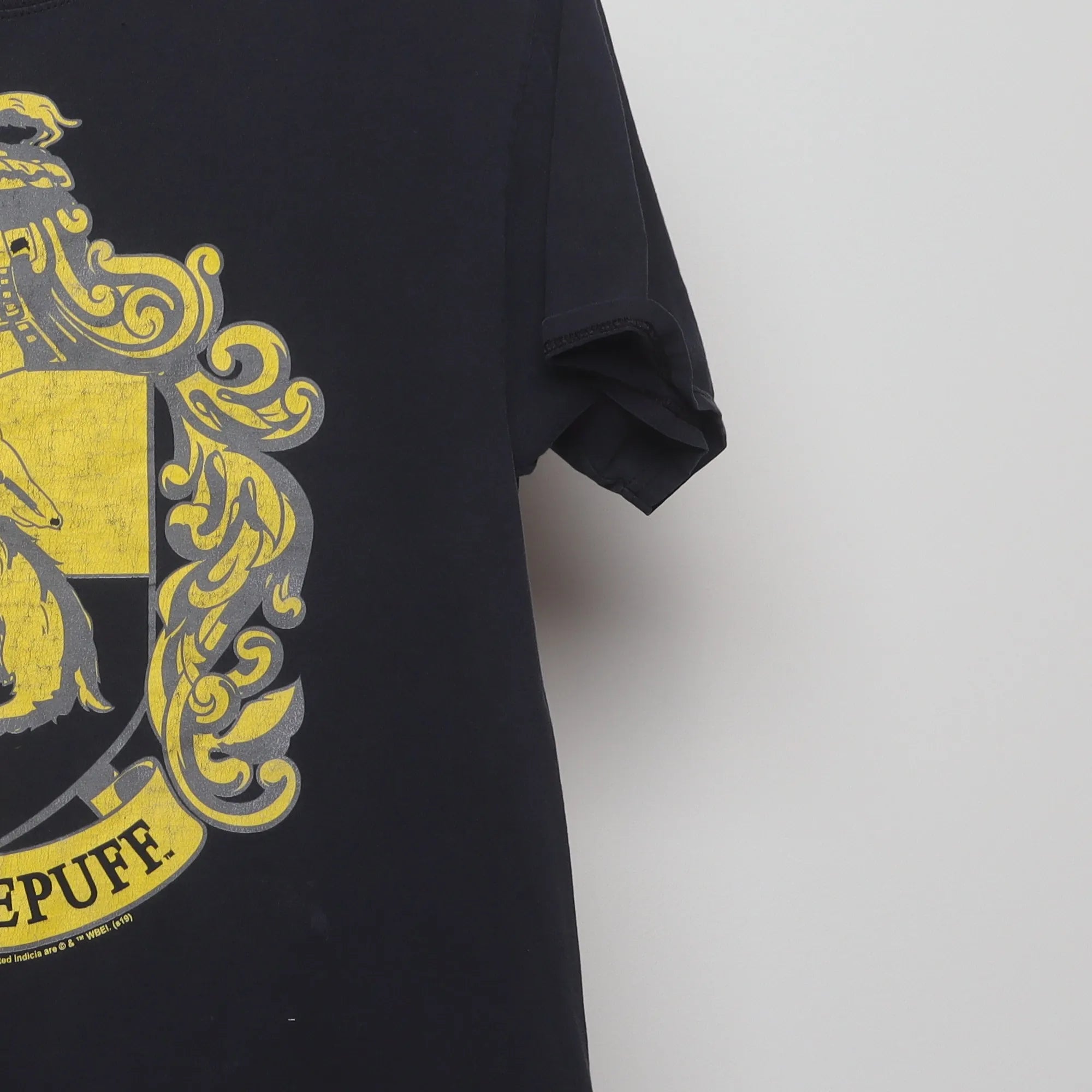 Close-up of the sleeve on the Vintage 2000s Harry Potter Hufflepuff Crest T-Shirt L