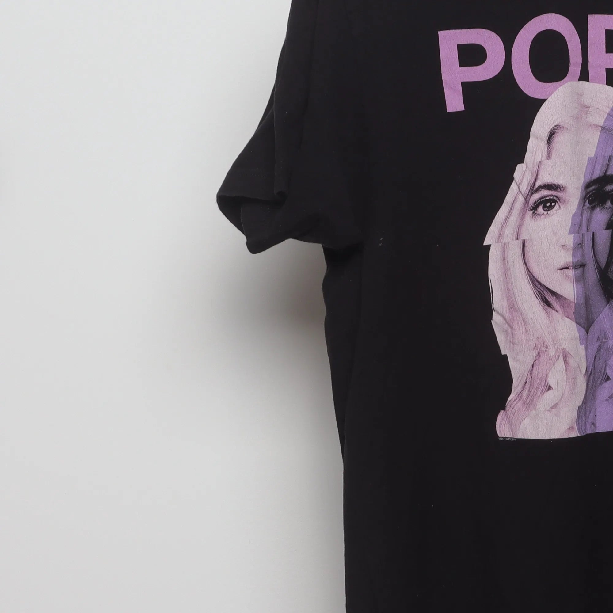Close-up of the sleeve on the Vintage 2010s Poppy Glitch Graphic Band T-Shirt L