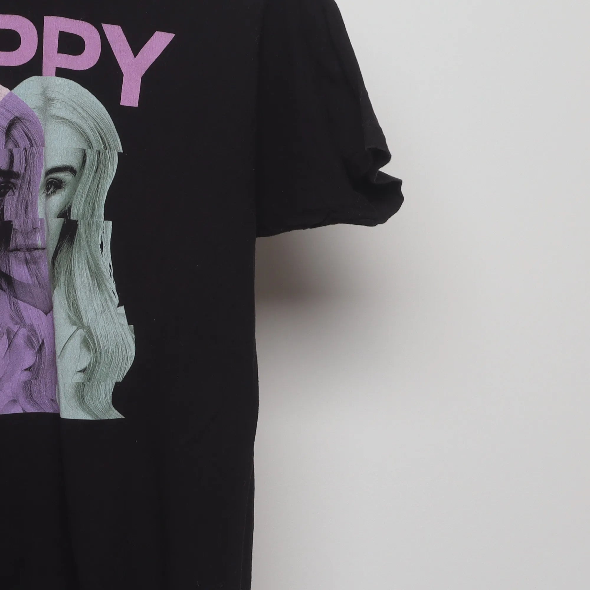 Close-up of the sleeve on the Vintage 2010s Poppy Glitch Graphic Band T-Shirt L