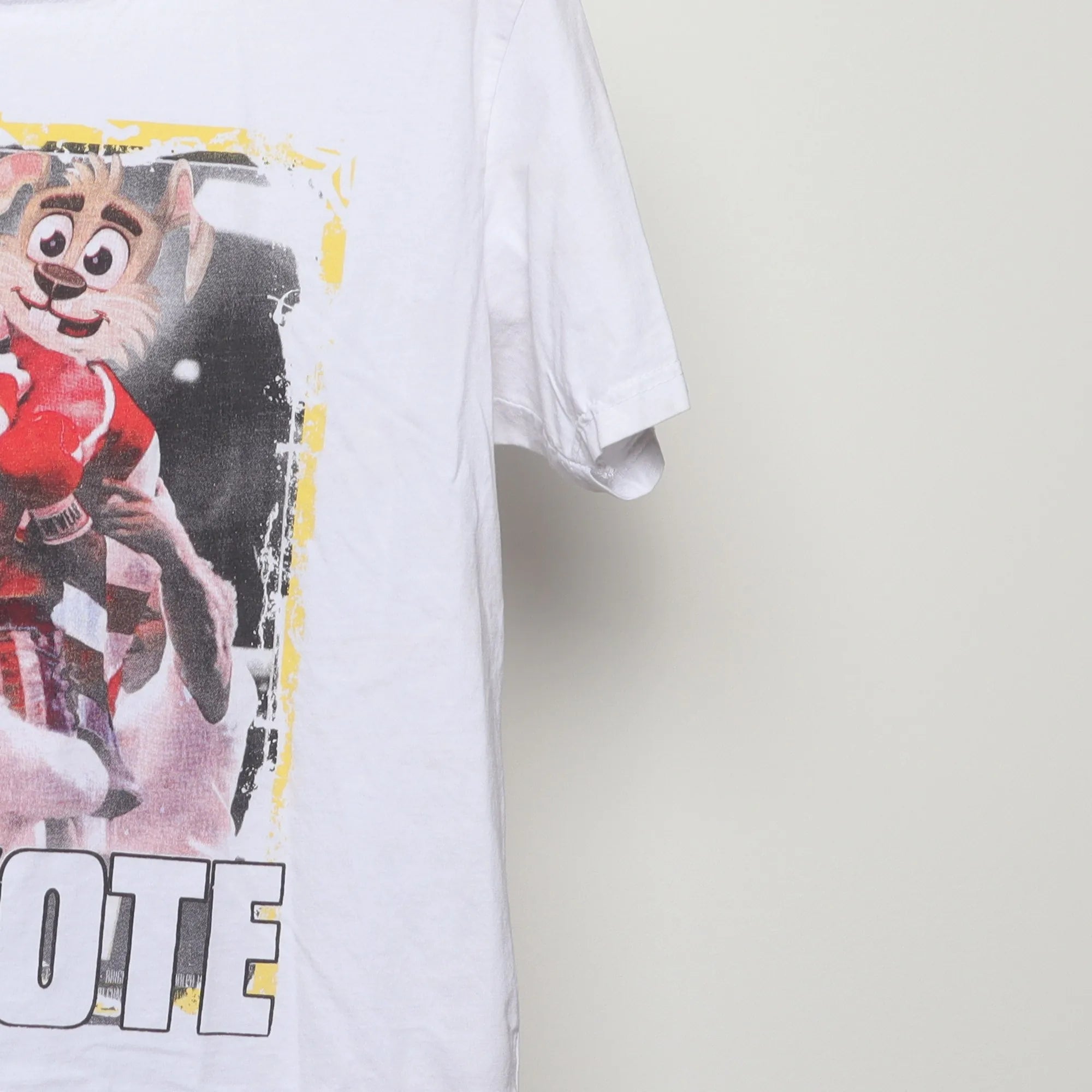 Close-up of the sleeve on the Vintage 2010s Spurs Coyote Rocky Parody Tee L