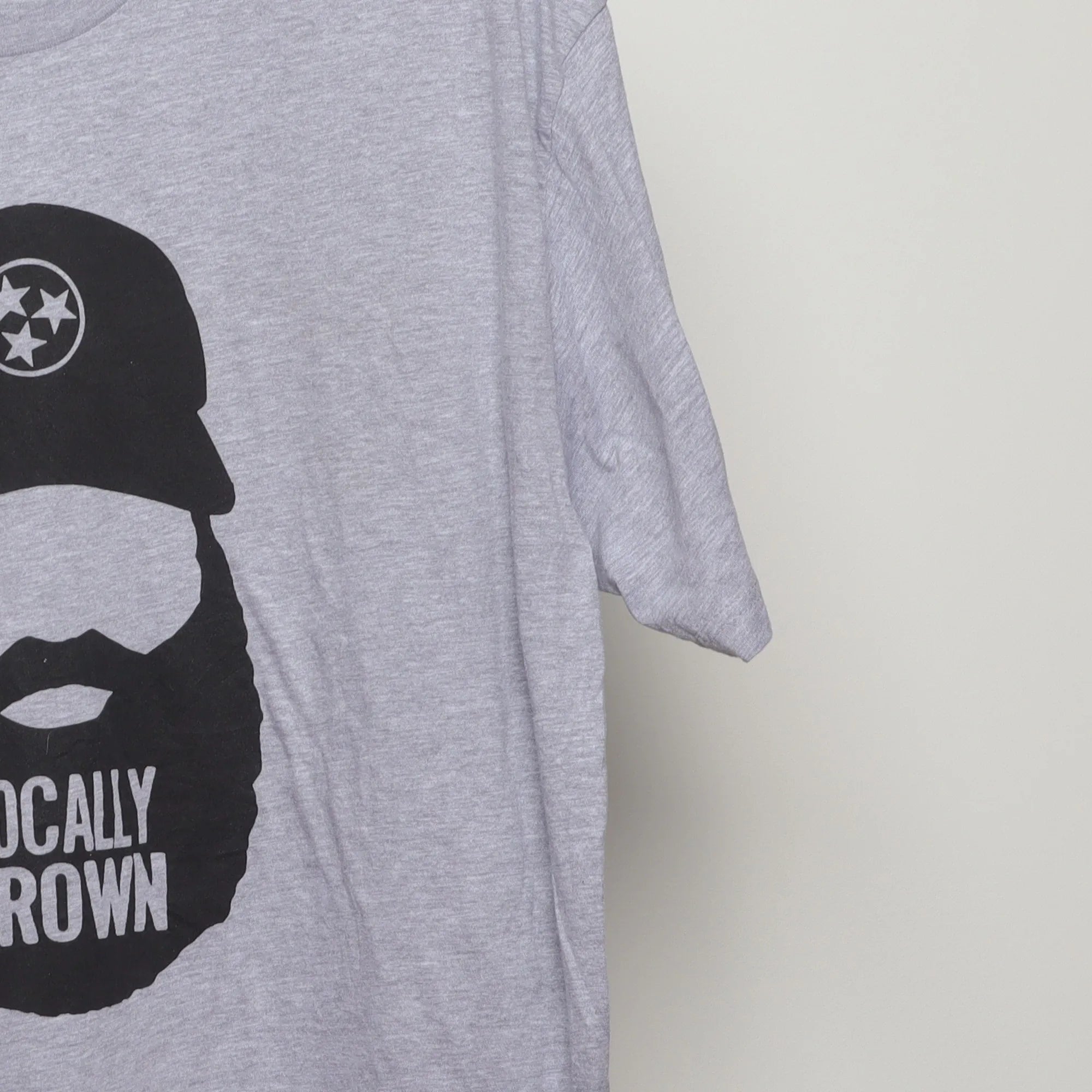 Close-up of the sleeve on the Vintage 2010s TN Locally Grown Beard T-Shirt XL