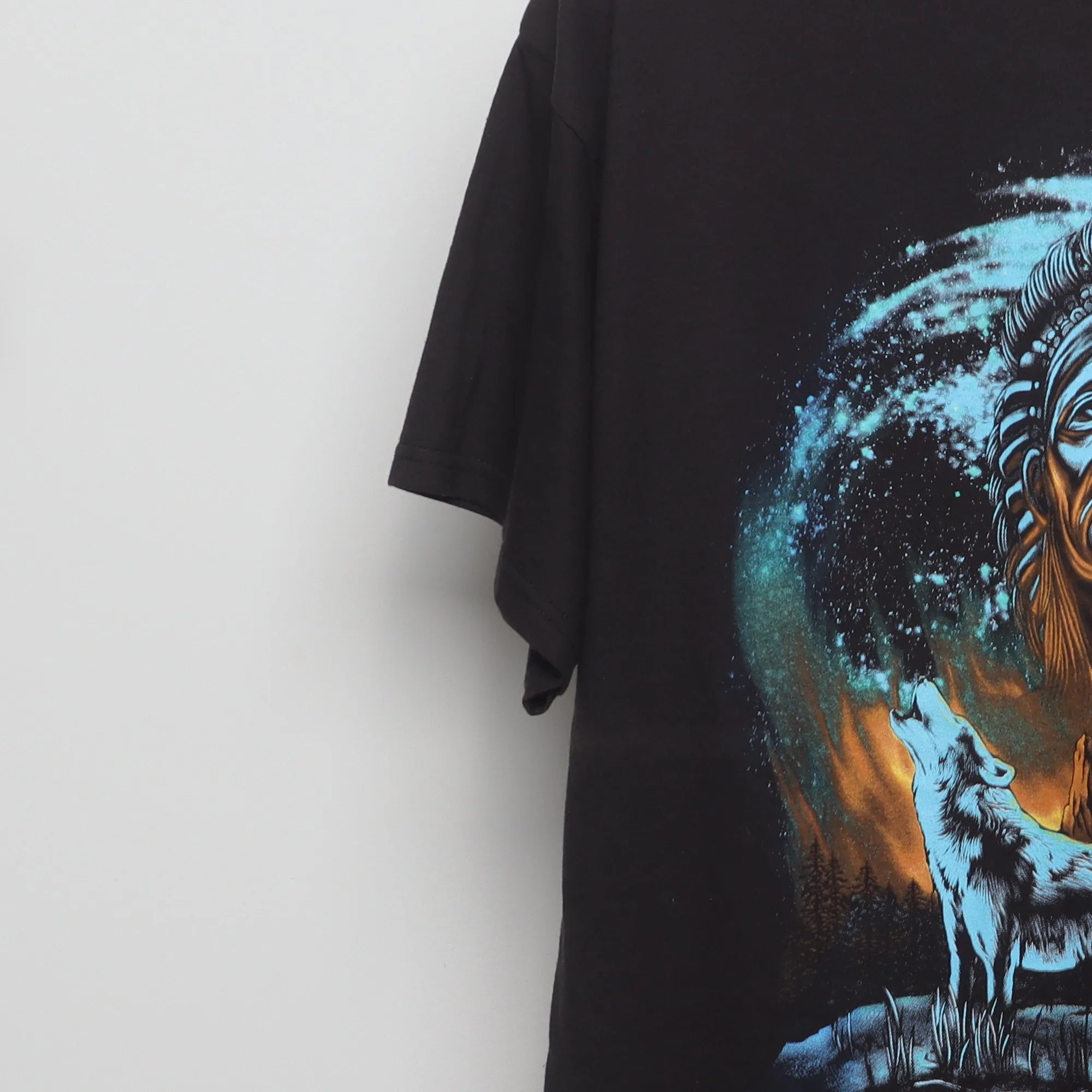 Close-up of the sleeve on the Vintage 90s Howling Wolf Native Chief Graphic T-Shirt L