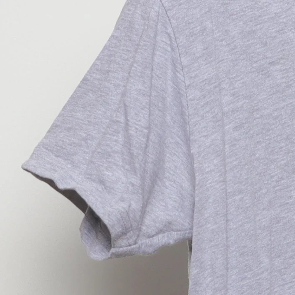 Close-up of the sleeve on the Vintage Modern Englewood Grass Farm "Cycling Cow" T-Shirt - M