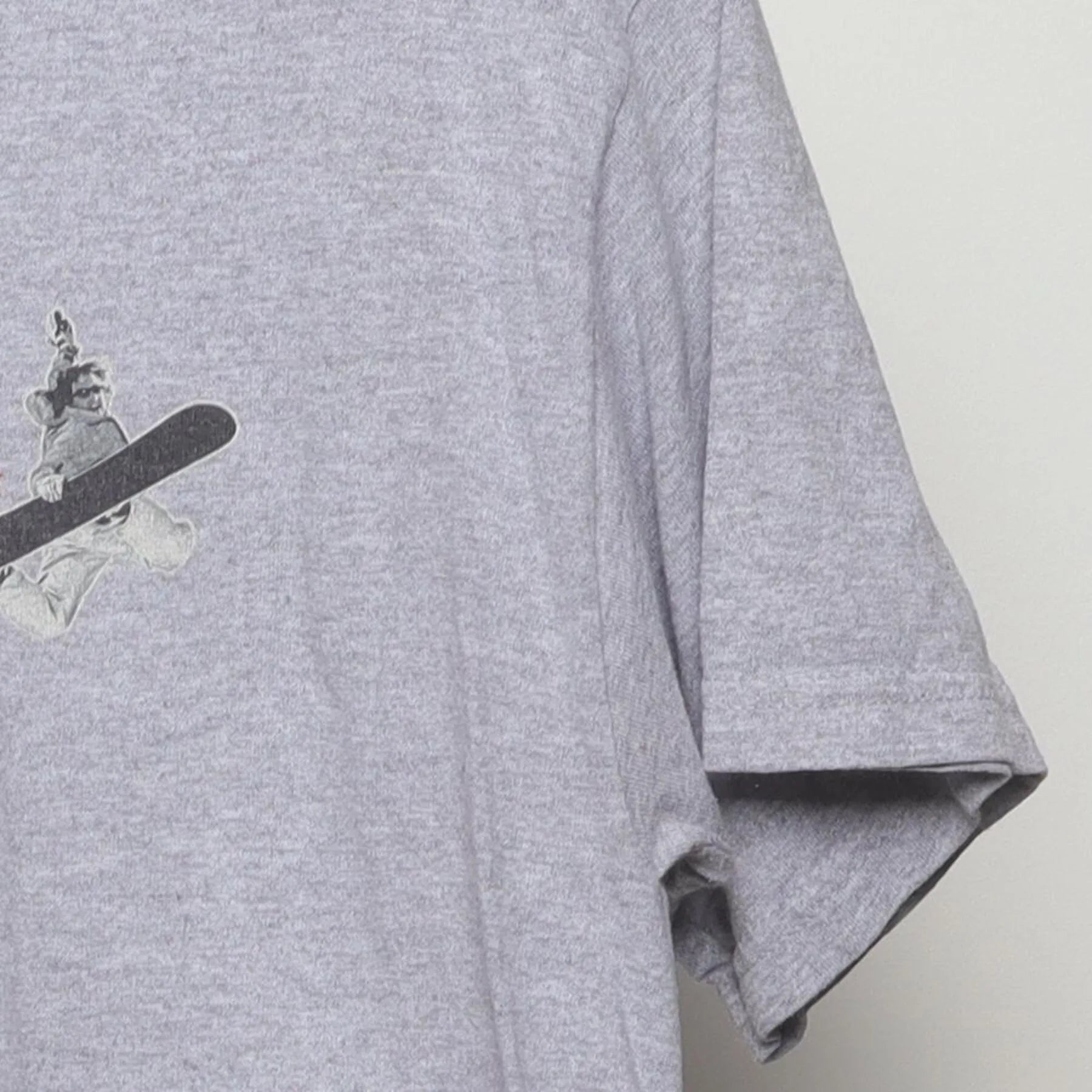 Close-up of the Right sleeve on the Vintage Y2K Steamboat "Chipped Teeth Ride On" T-Shirt - M