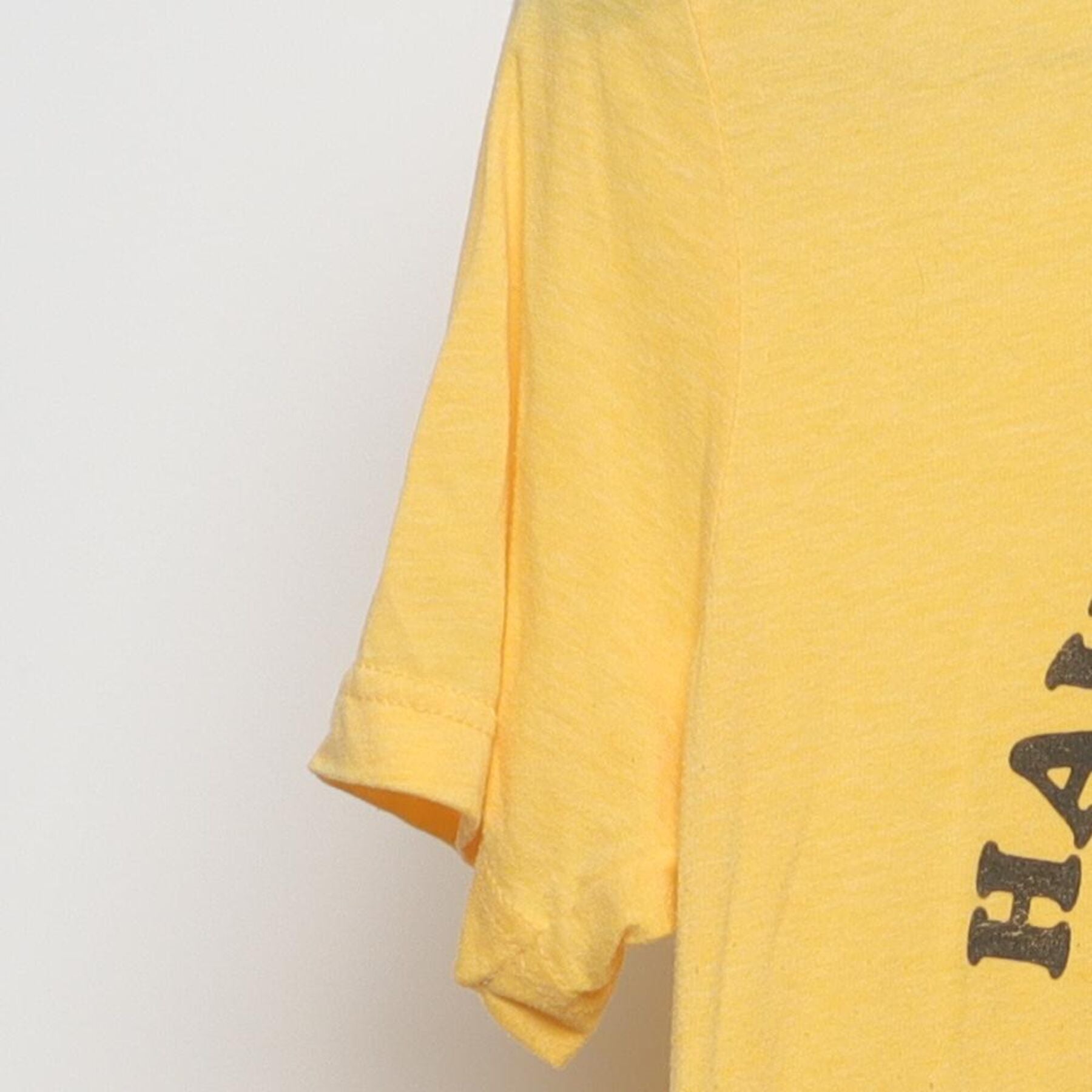 Close-up of the Left sleeve on the Vintage 1970s walk in love. "Have A Nice Day" Smiley Face T-Shirt - XS