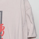 Close-up of the single stitch sleeve on the Vintage Y2K Fashion Nova "Live Fast Luxury Dreams" T-Shirt - L