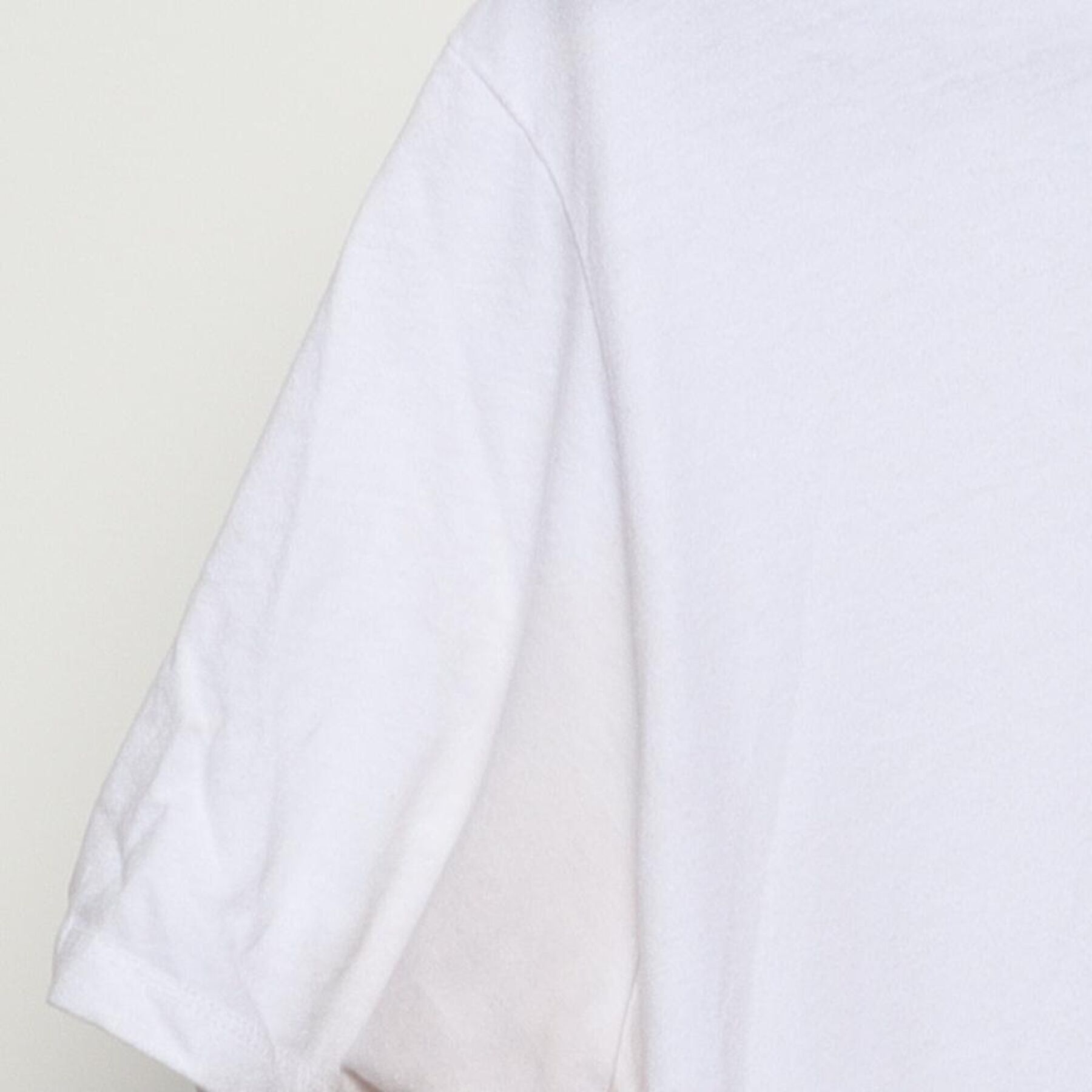 Close-up of the Left sleeve on the Vintage Y2K 100% "Stars & Slash" T-Shirt - M