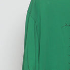 Left sleeve detail of Vintage Nike Dri-Fit Green Graphic T-Shirt Cracked Shield Swoosh Logo