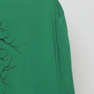 Right sleeve detail of Vintage Nike Dri-Fit Green Graphic T-Shirt Cracked Shield Swoosh Logo