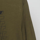 Right sleeve detail of Nike 'Just Do It' Glitch Graphic Dri-Fit T-Shirt Olive Green