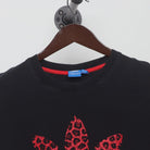 Close-up of the collar and tag on the Vintage Y2K Adidas "Red Leopard Trefoil Logo" T-Shirt - XL