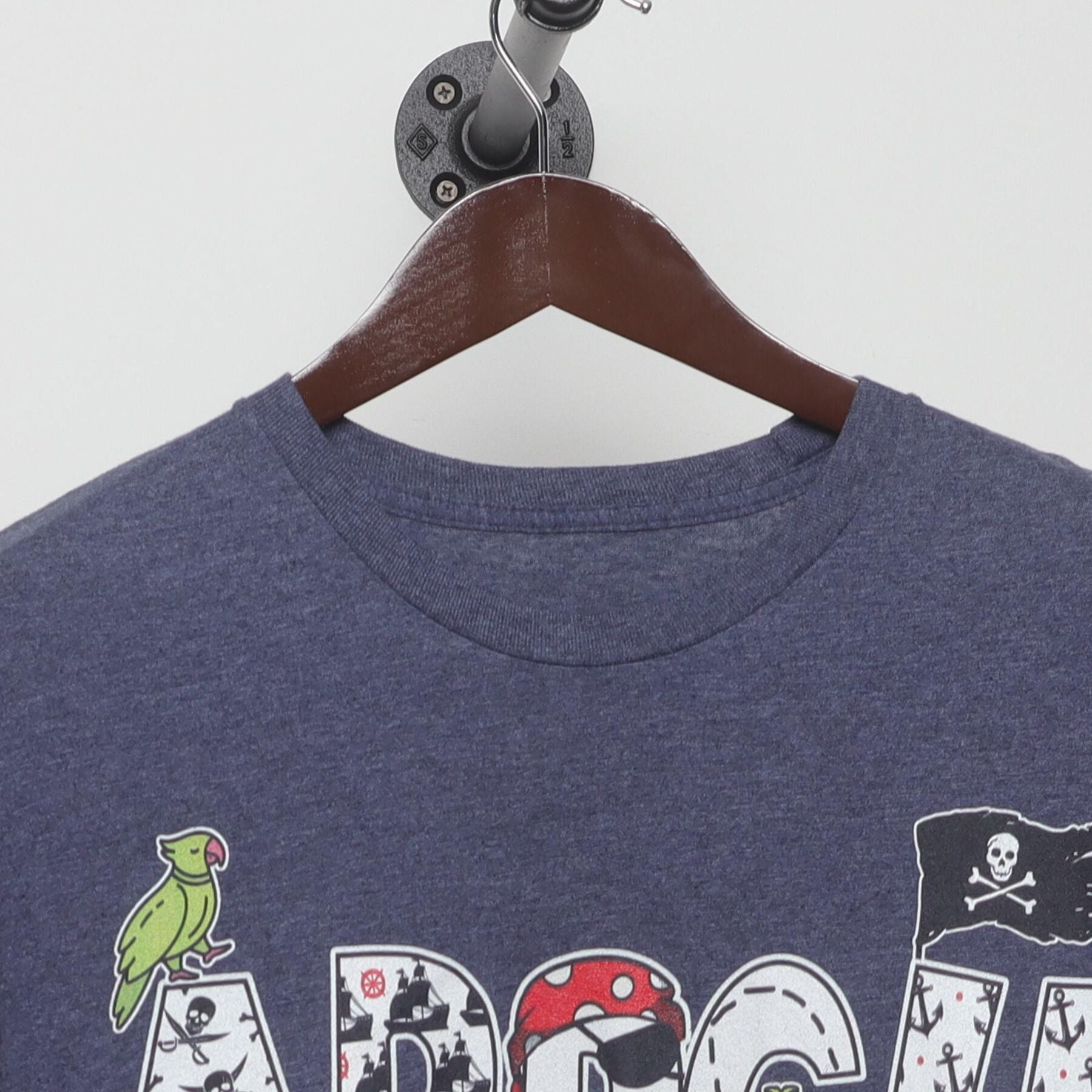 Close-up of the collar and tag on the Vintage 2010s Pirate Graphic "ARRGH" T-Shirt - M