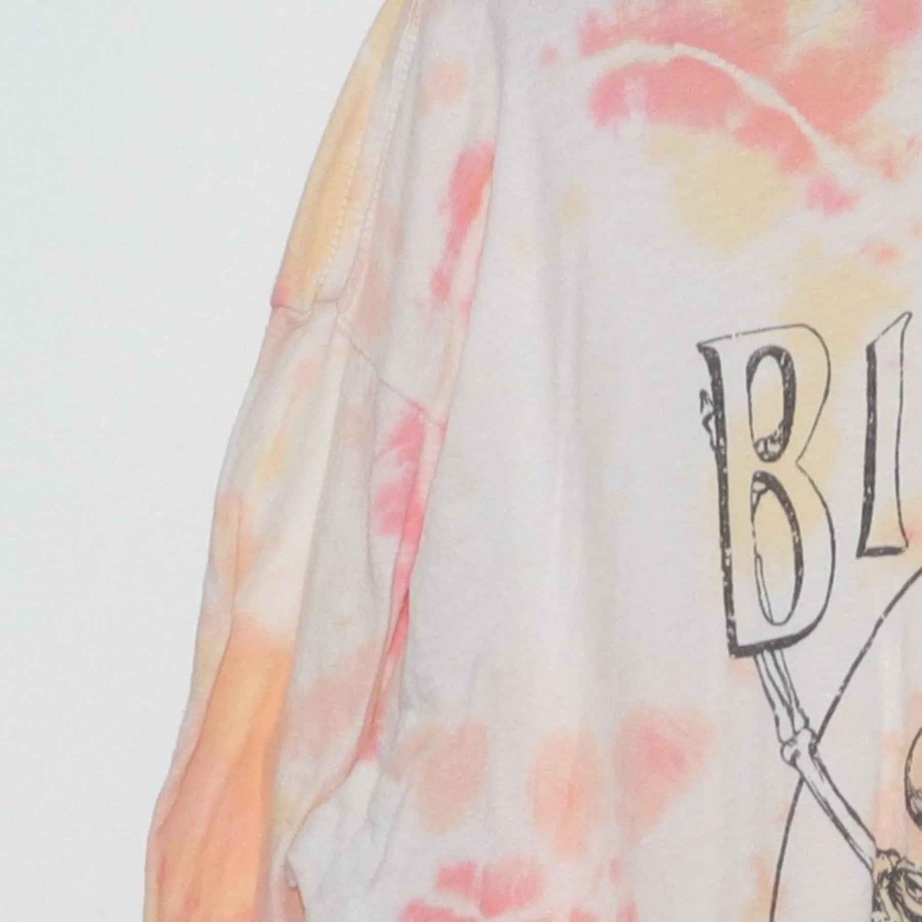 Close-up of the Left sleeve on the Vintage Y2K Billabong "Dancing Skeletons" T-Shirt - L