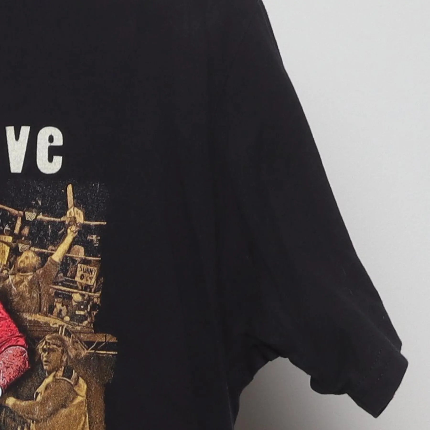 Close-up of the Right sleeve on the Vintage Y2K WWF "The Chainsaw Charlie Massacre" T-Shirt - M