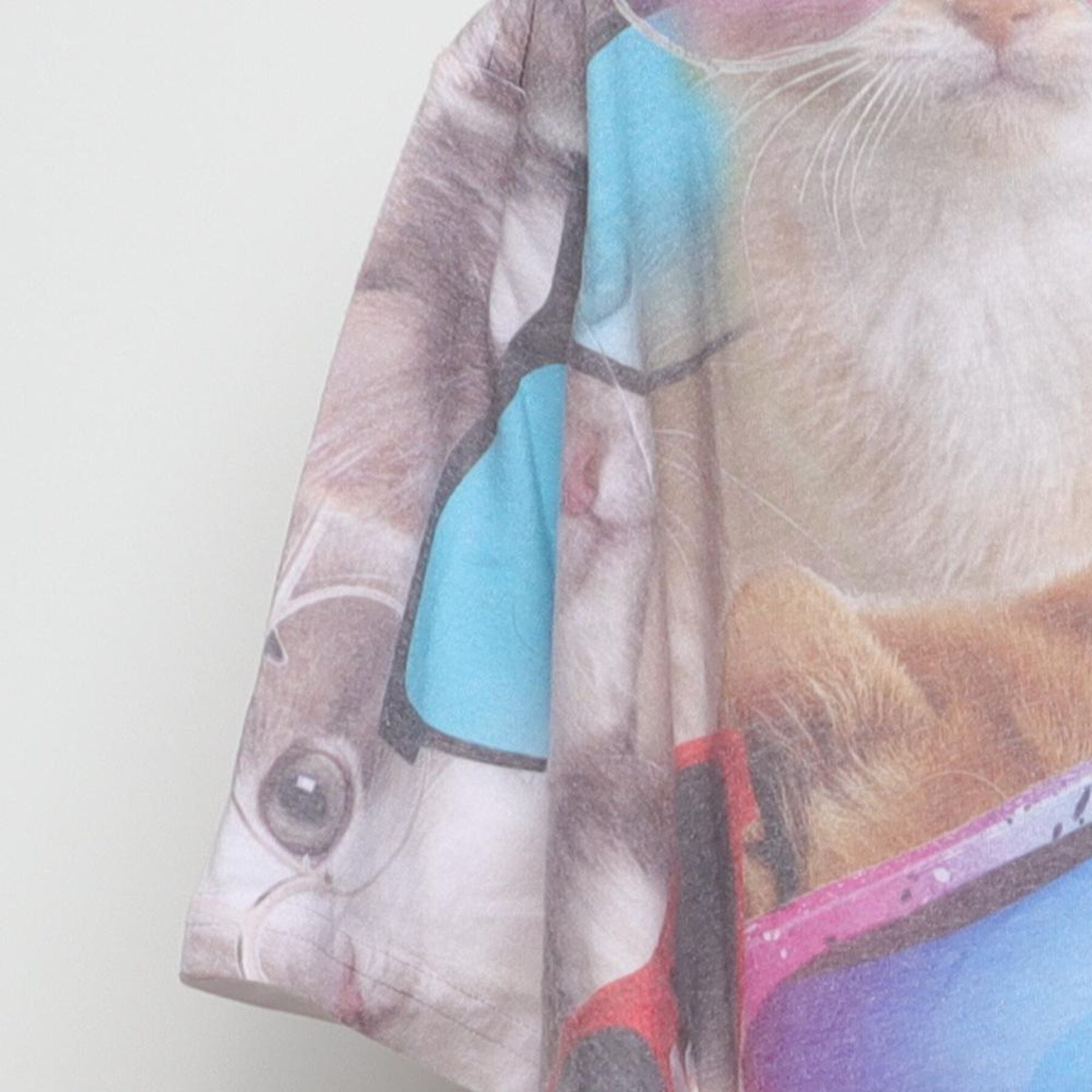 Close-up of the Left sleeve on the Vintage Y2K-Era The Mountain "Cats in Sunglasses" All Over Print T-Shirt - M