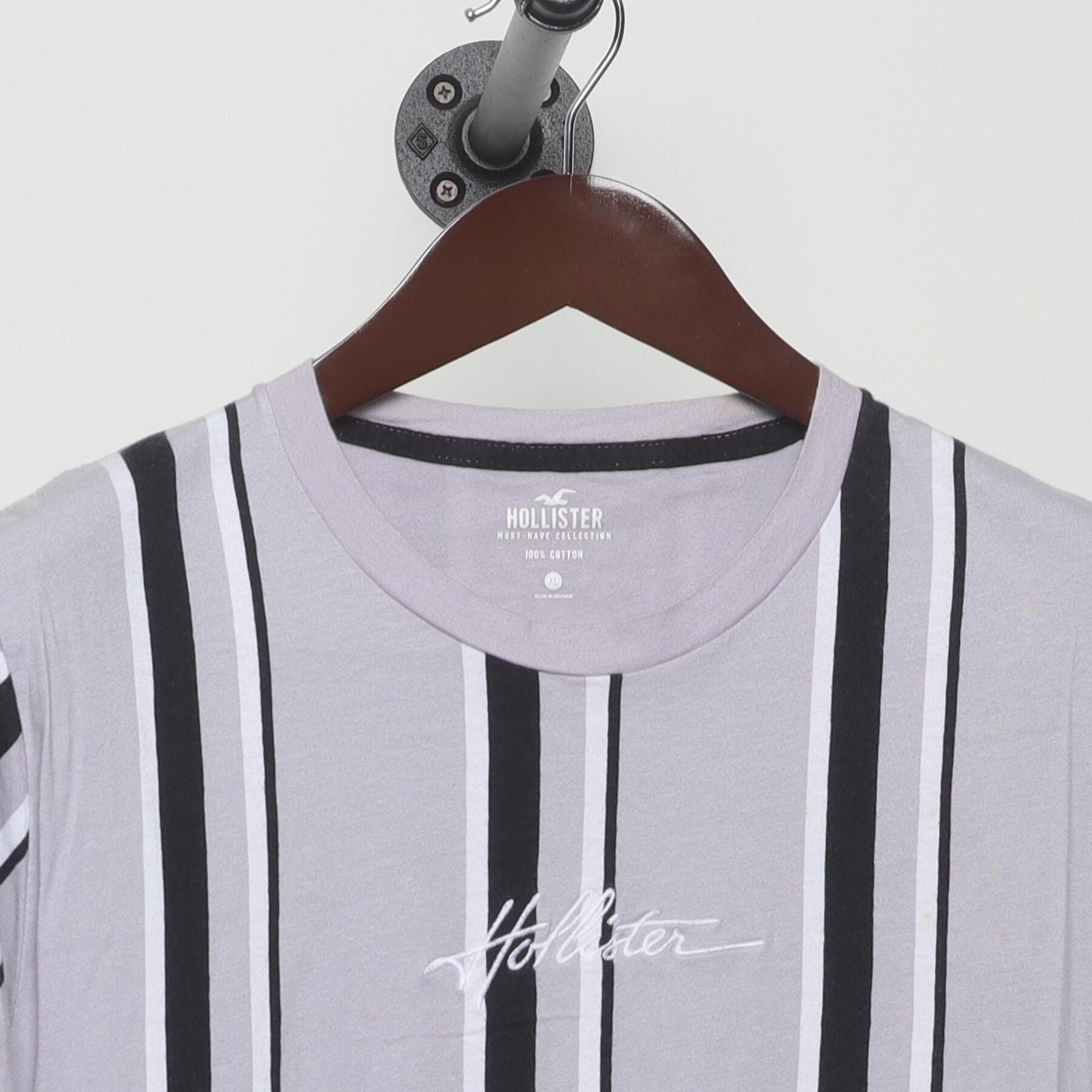 Close-up of the collar and tag on the Vintage Y2K Hollister "Embroidered Script Logo Striped" T-Shirt - M