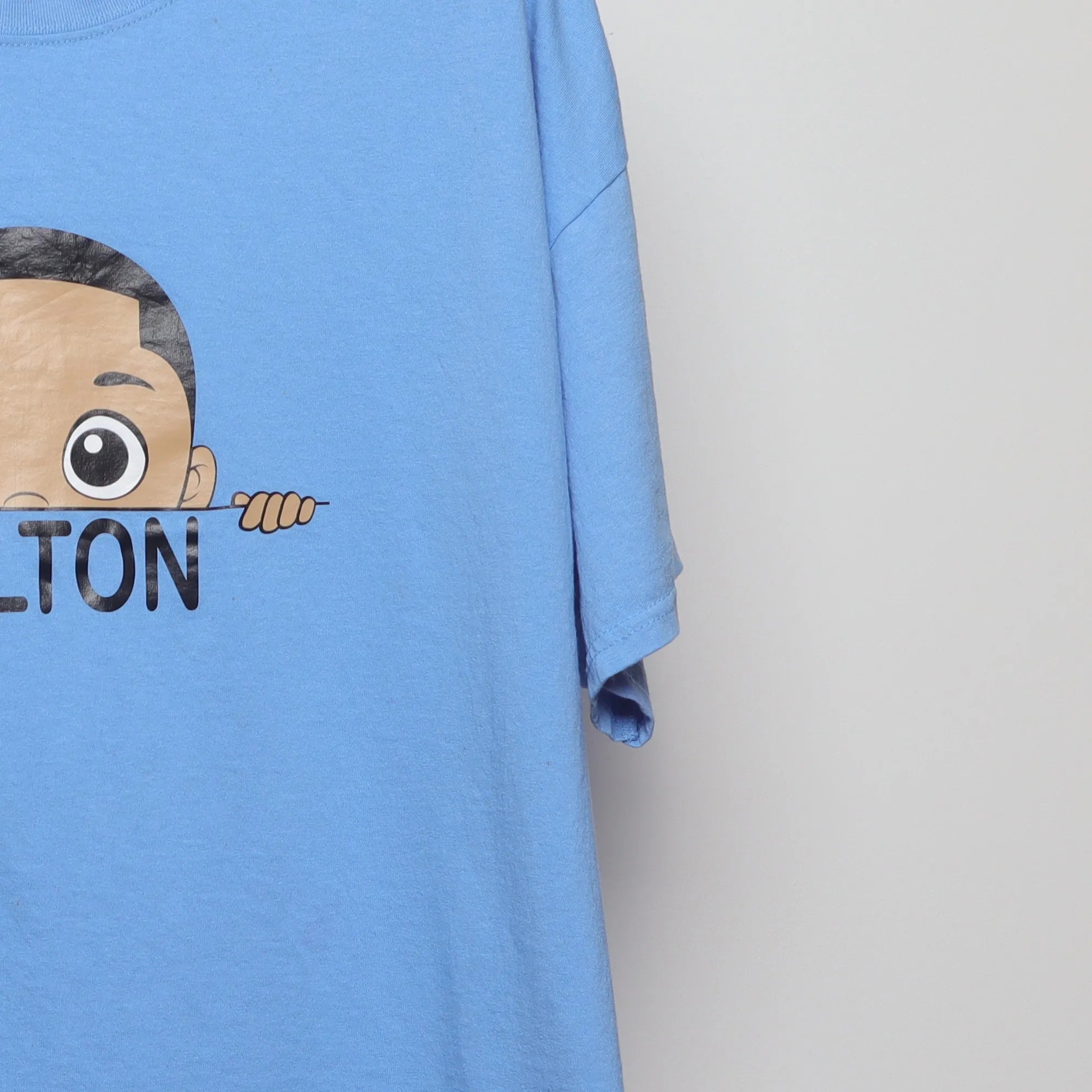 Close-up of the sleeve on the Modern Y2K Style Colton Cartoon Graphic T-Shirt XL