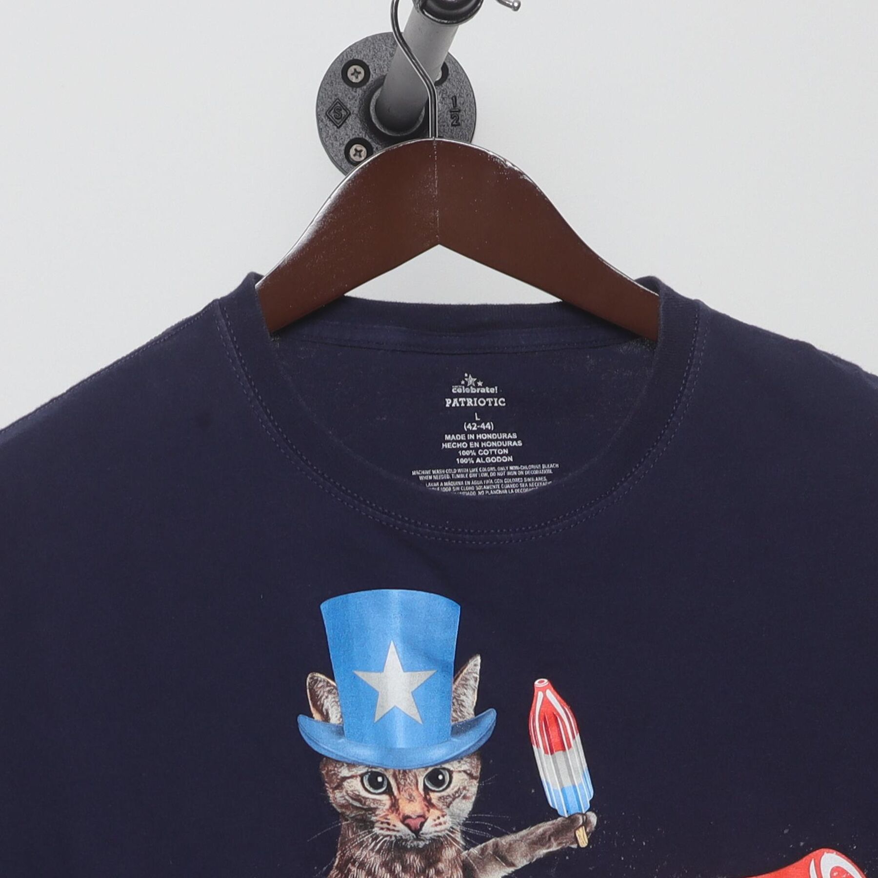 Close-up of the collar and tag on the Vintage Y2K Celebrate! Patriotic "Cat Riding Rocket Pop" T-Shirt - M
