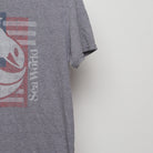 Close-up of the sleeve on the Retro Sea World American Flag Graphic Tee M
