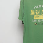 Close-up of the sleeve on the Vintage 00s John Deere Farm Supply Graphic T-Shirt L