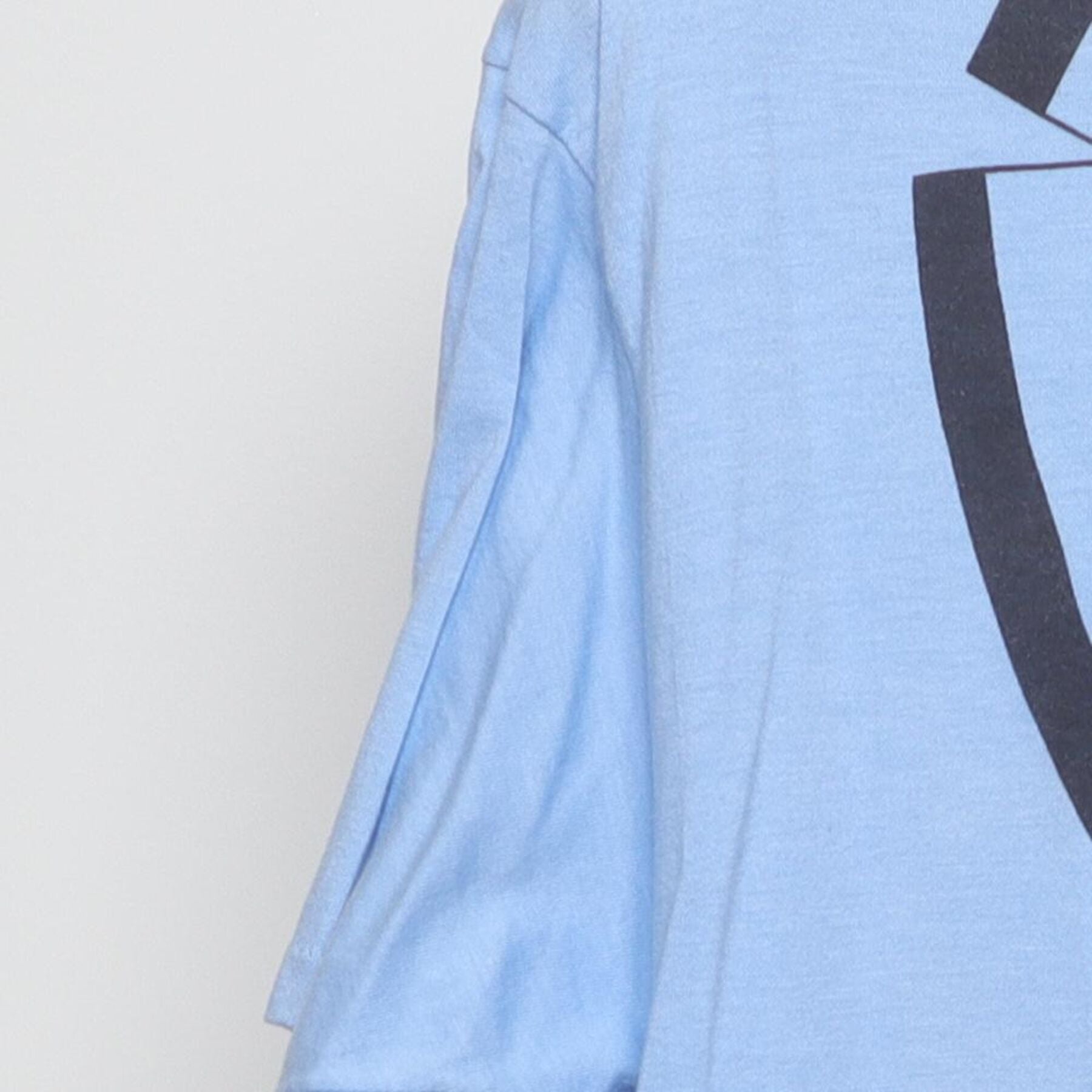 Close-up of the single stitch sleeve on the Vintage 1980s Roach "Tuxedo" T-Shirt - M