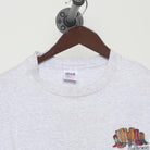 Close-up of the collar and tag on the Vintage 1990s Cherokee "Carved Figures" T-Shirt - L