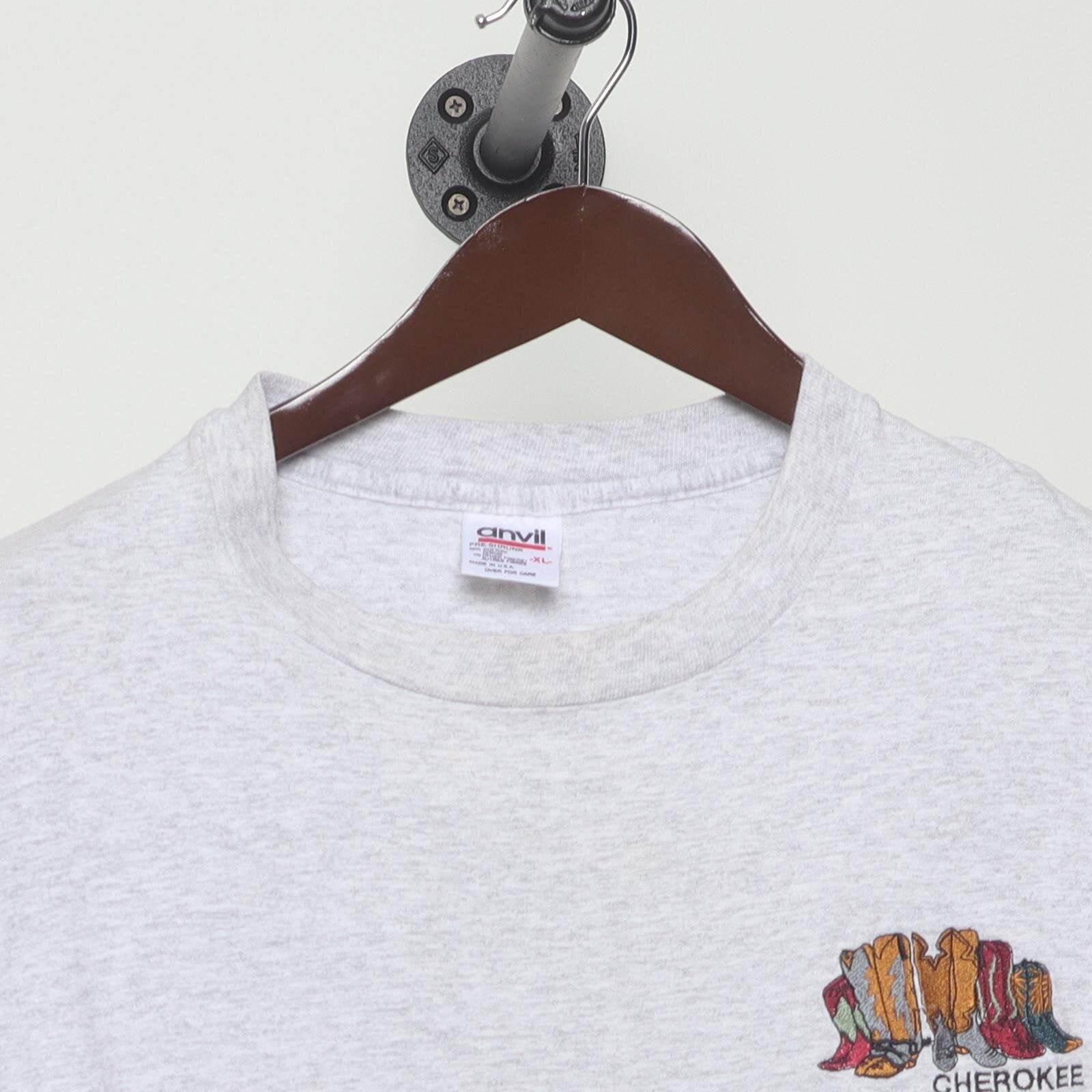 Close-up of the collar and tag on the Vintage 1990s Cherokee "Carved Figures" T-Shirt - L