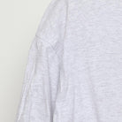 Close-up of the single stitch sleeve on the Vintage 1990s Cherokee "Carved Figures" T-Shirt - L