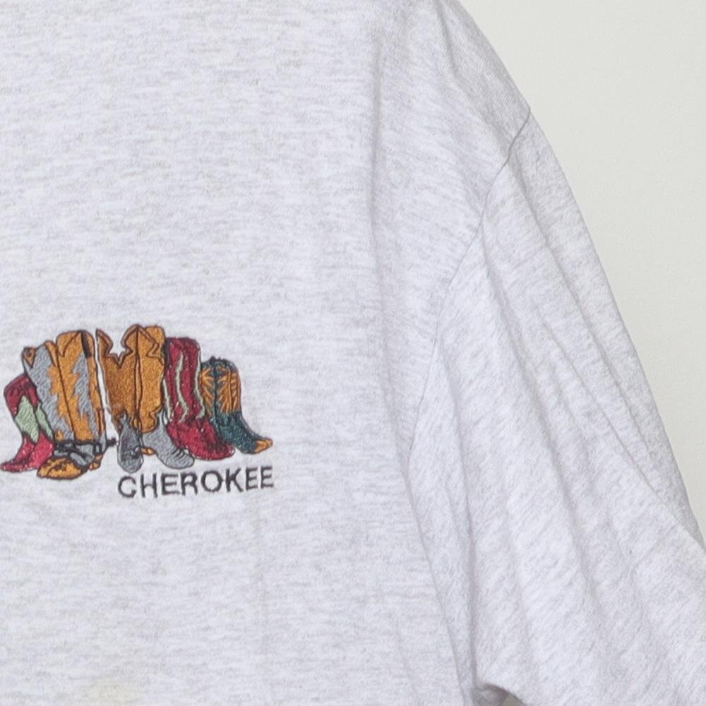 Close-up of the single stitch sleeve on the Vintage 1990s Cherokee "Carved Figures" T-Shirt - L