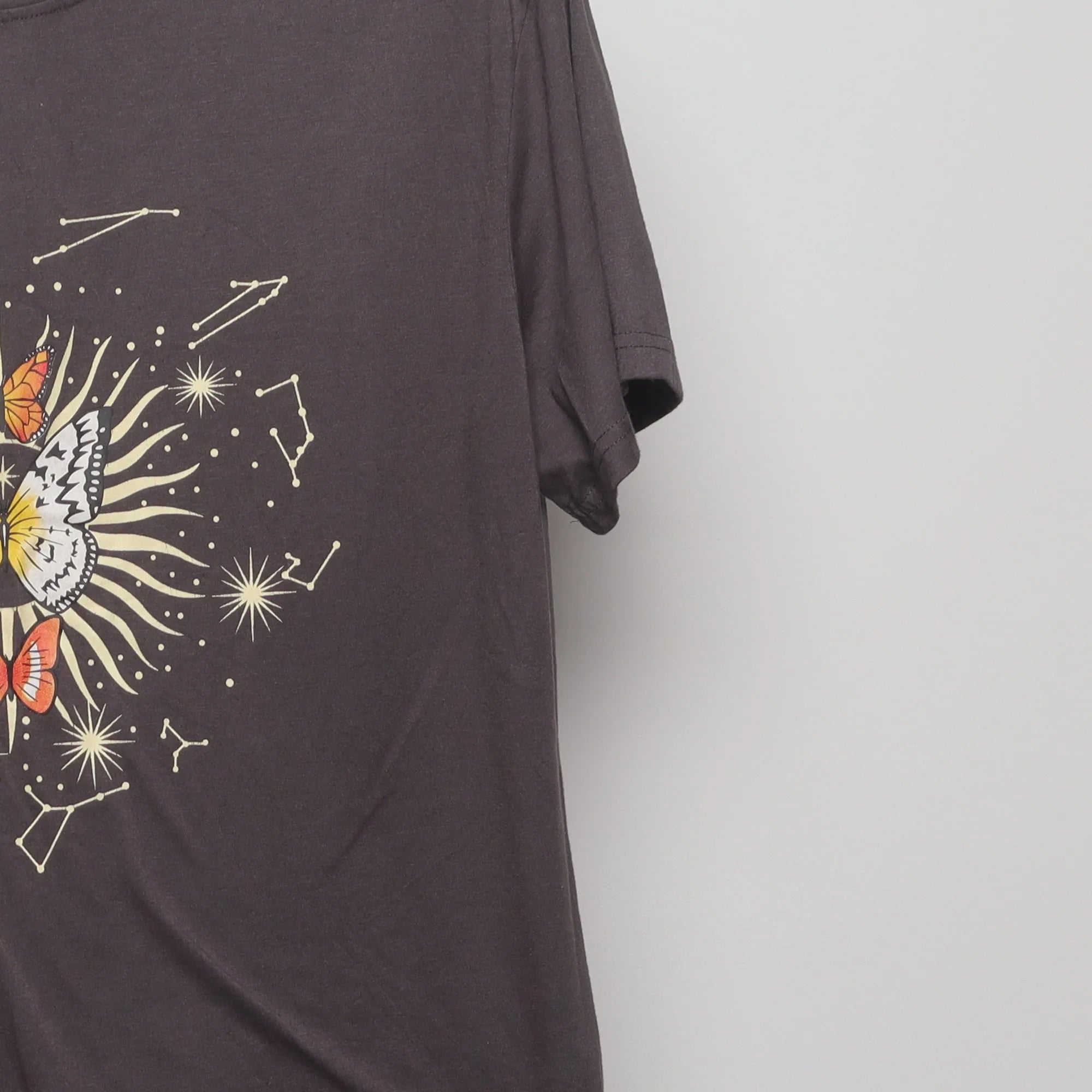 Close-up of the sleeve on the Vintage 2000s Celestial Butterfly Graphic Tee M