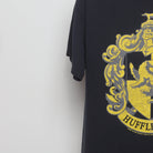 Close-up of the sleeve on the Vintage 2000s Harry Potter Hufflepuff Crest T-Shirt L