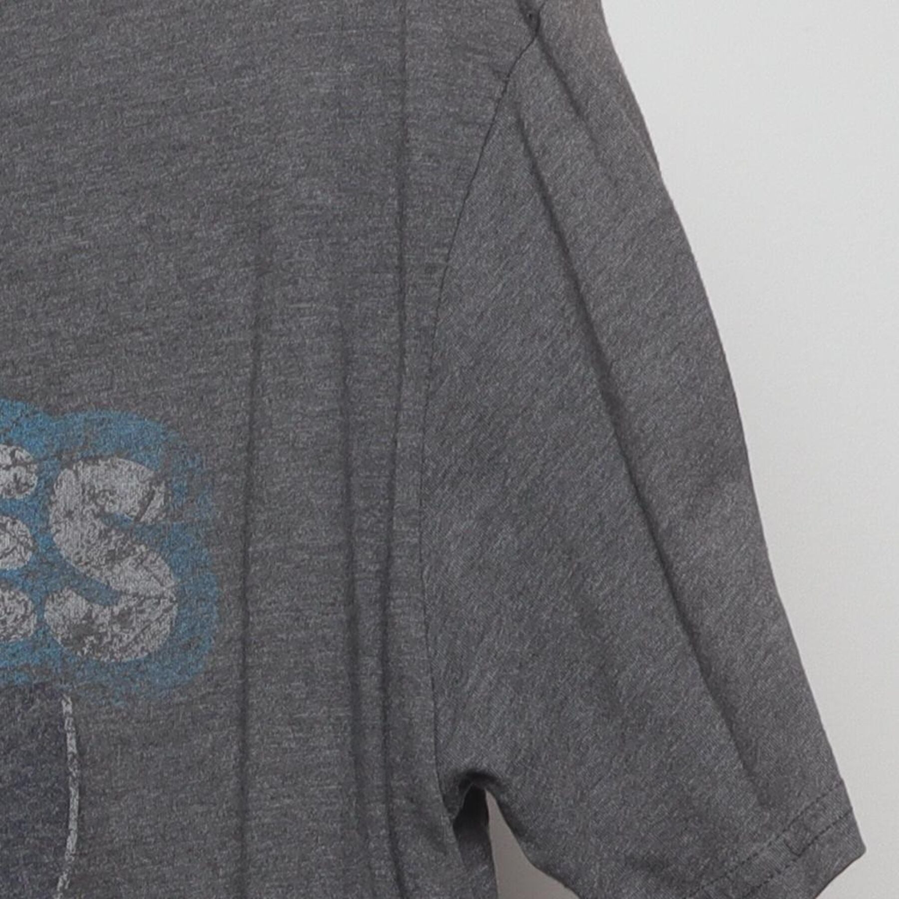 Close-up of the Right sleeve on the Vintage Y2K Homage x Howies Hockey Tape "Mascot Logo" T-Shirt - L
