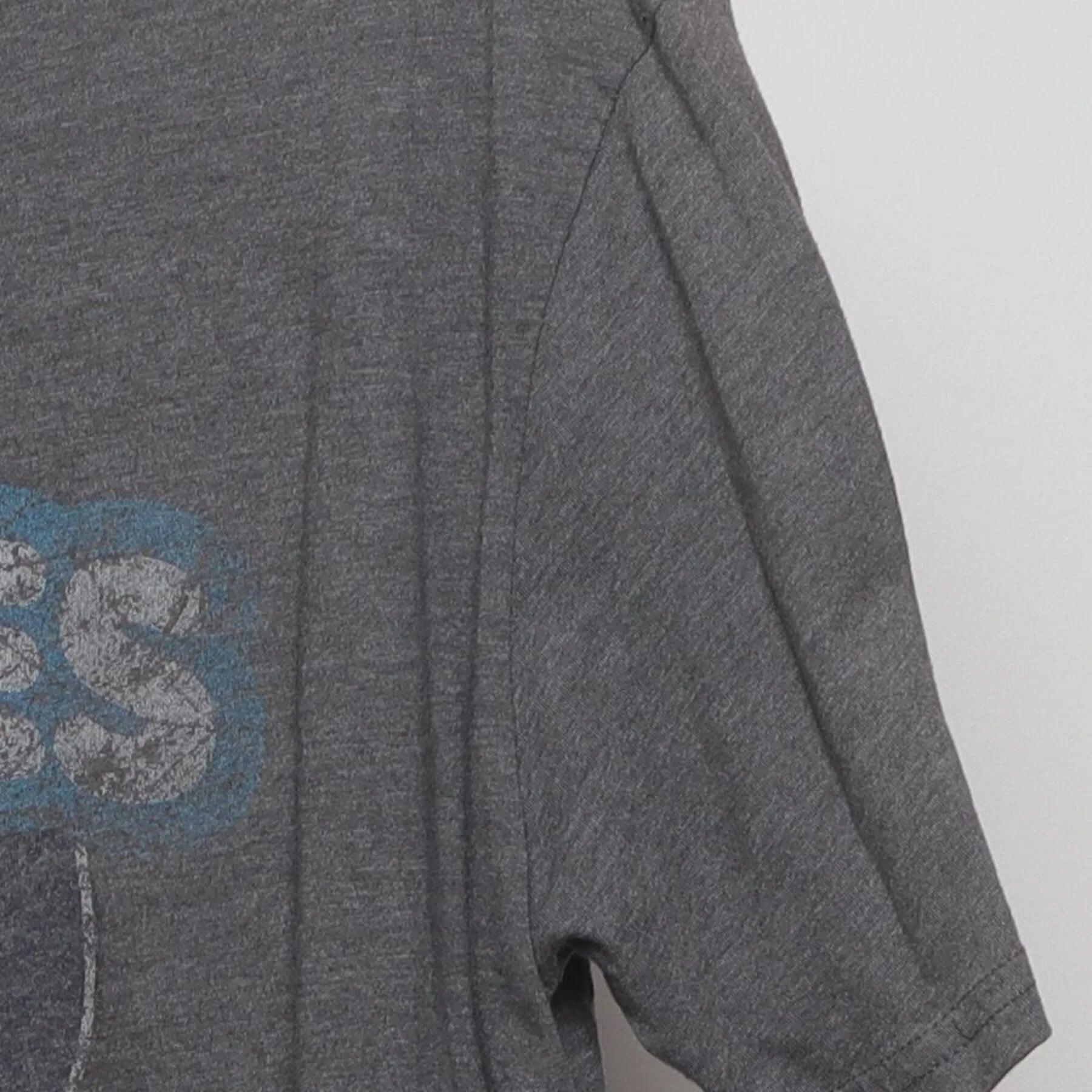 Close-up of the Right sleeve on the Vintage Y2K Homage x Howies Hockey Tape "Mascot Logo" T-Shirt - L