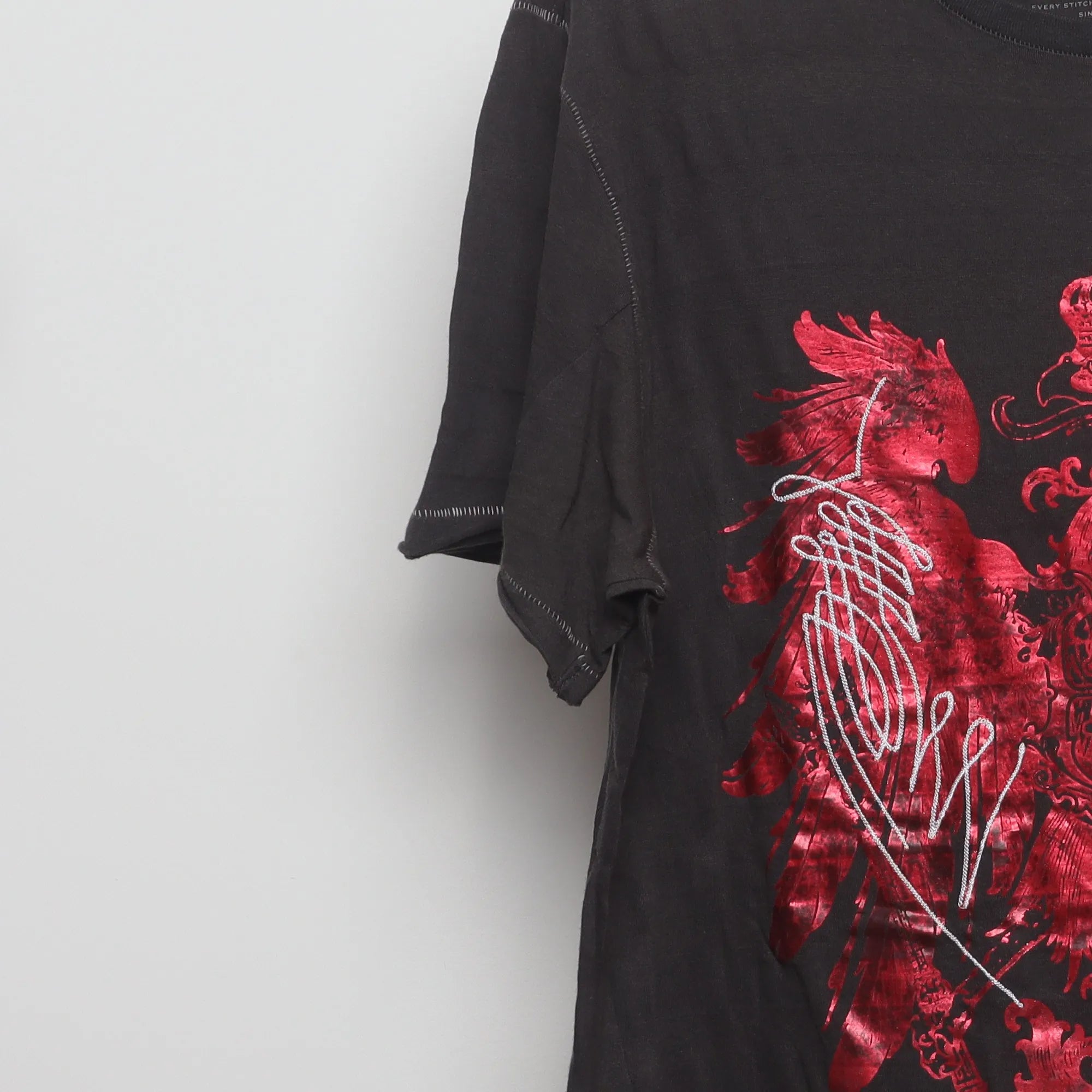 Close-up of the sleeve on the Vintage 2000s Marc Ecko Foil Eagle T-Shirt XL