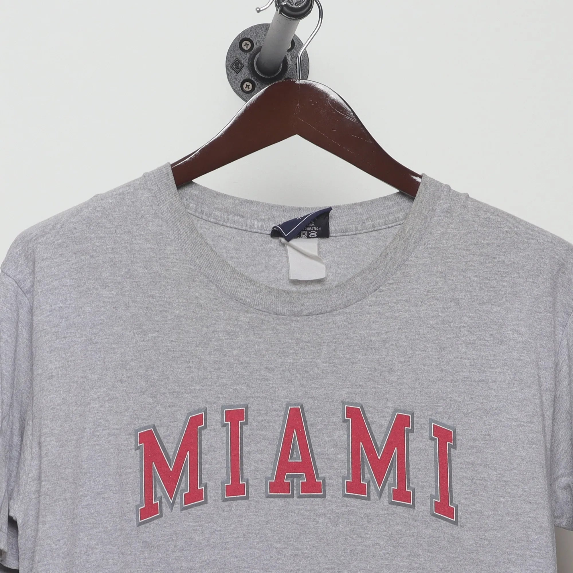 Close-up of the collar and tag on the Vintage 2000s Miami Collegiate Arch Logo T-Shirt L