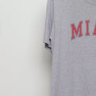 Close-up of the sleeve on the Vintage 2000s Miami Collegiate Arch Logo T-Shirt L