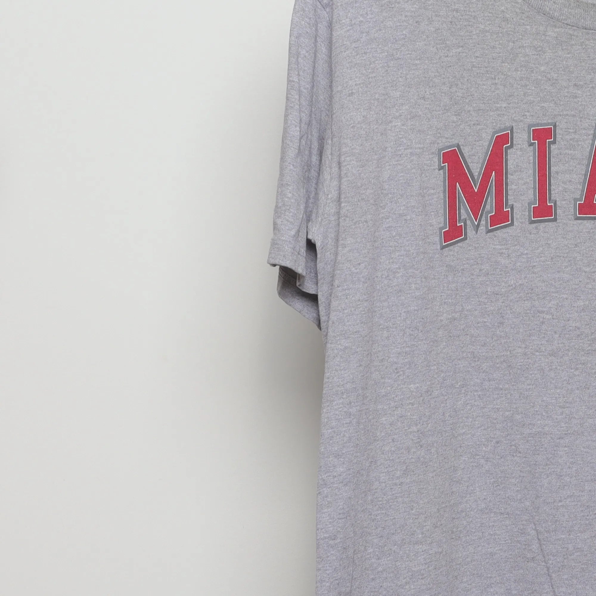 Close-up of the sleeve on the Vintage 2000s Miami Collegiate Arch Logo T-Shirt L