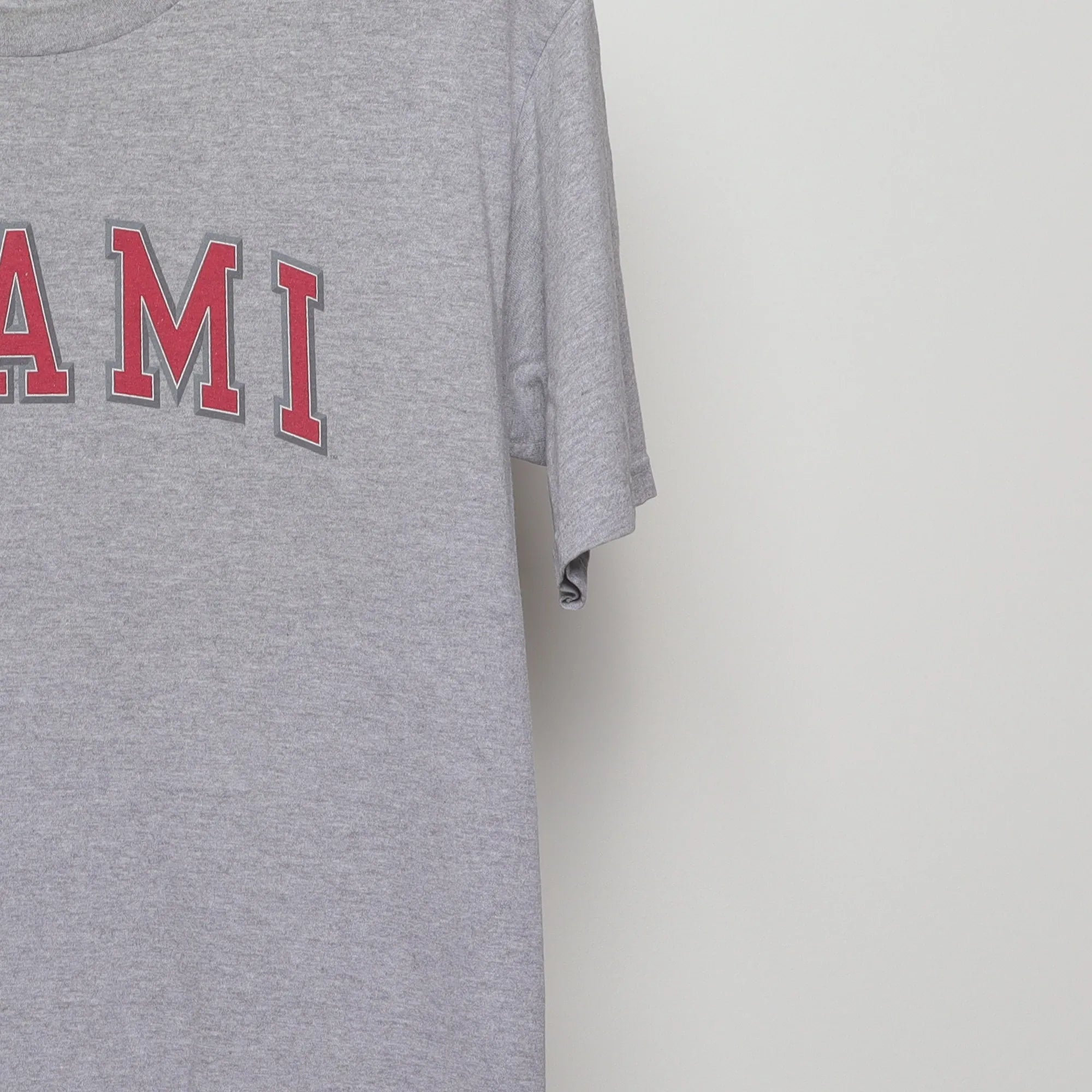 Close-up of the sleeve on the Vintage 2000s Miami Collegiate Arch Logo T-Shirt L