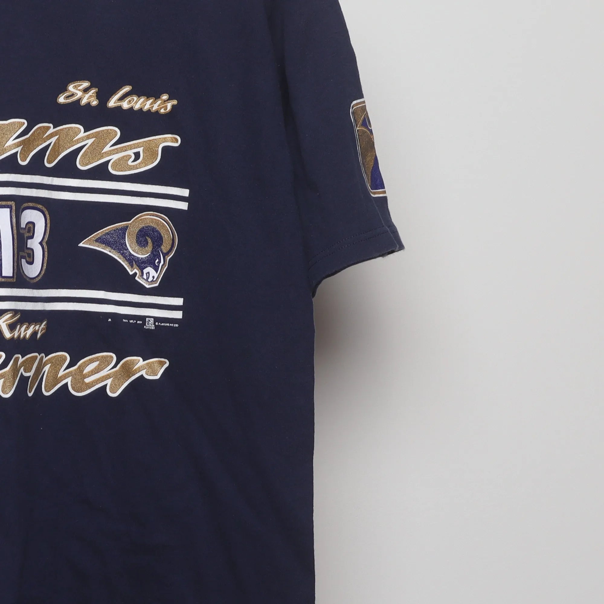 Close-up of the sleeve on the Vintage 2000s St. Louis Rams Kurt Warner T-Shirt M