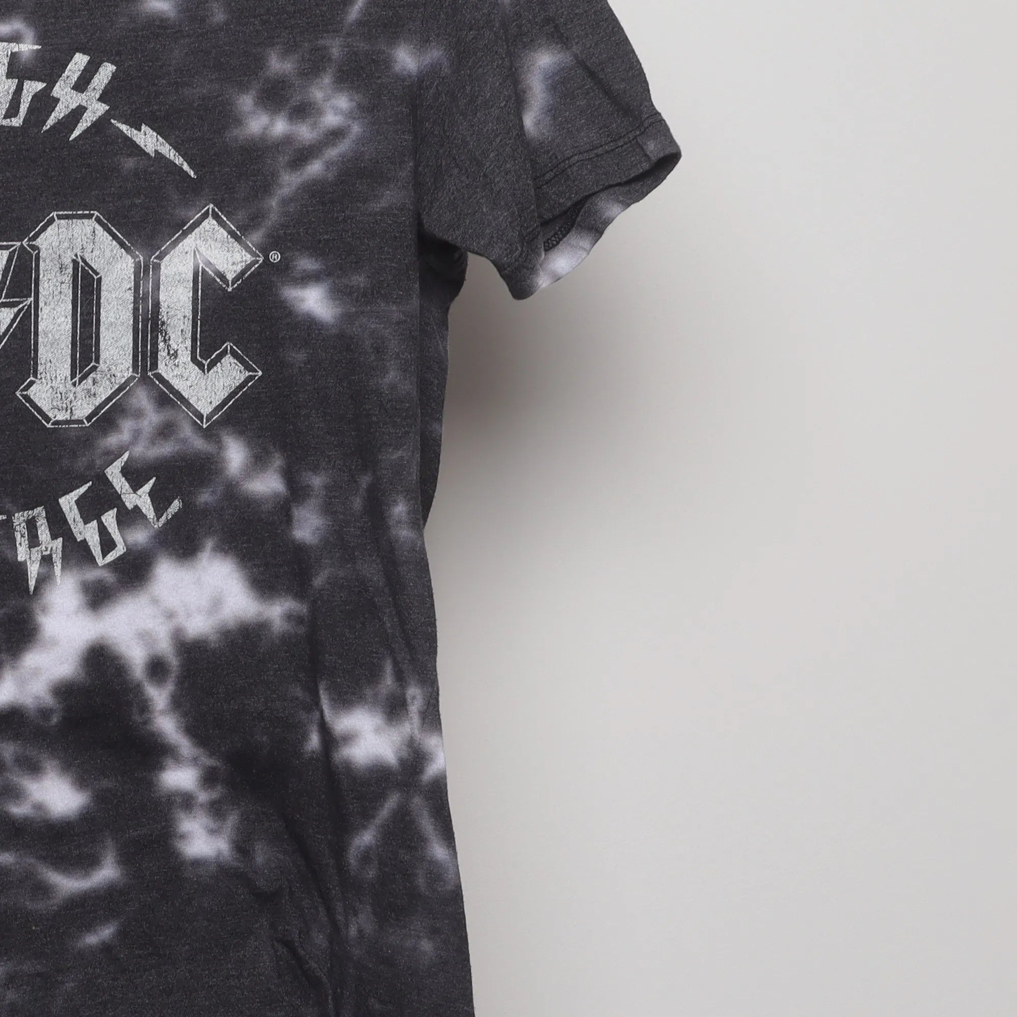 Close-up of the sleeve on the Vintage 2010s AC/DC High Voltage Tie-Dye Tee S