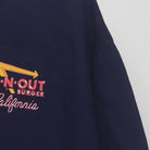 Close-up of the sleeve on the Vintage 2010s In-N-Out Burger "Classic Cars Sunset" T-Shirt - XL