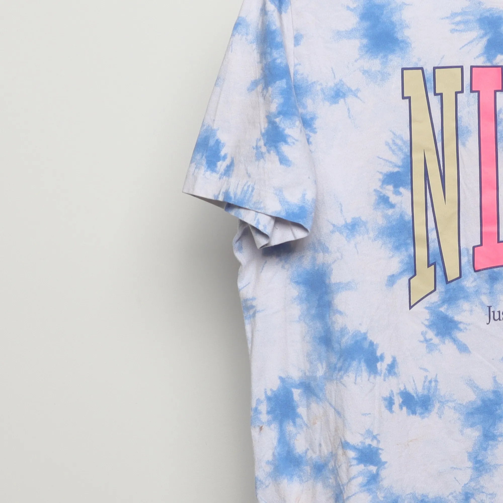 Close-up of the sleeve on the Vintage 2010s Nike Tie-Dye Peace Graphic Tee XL