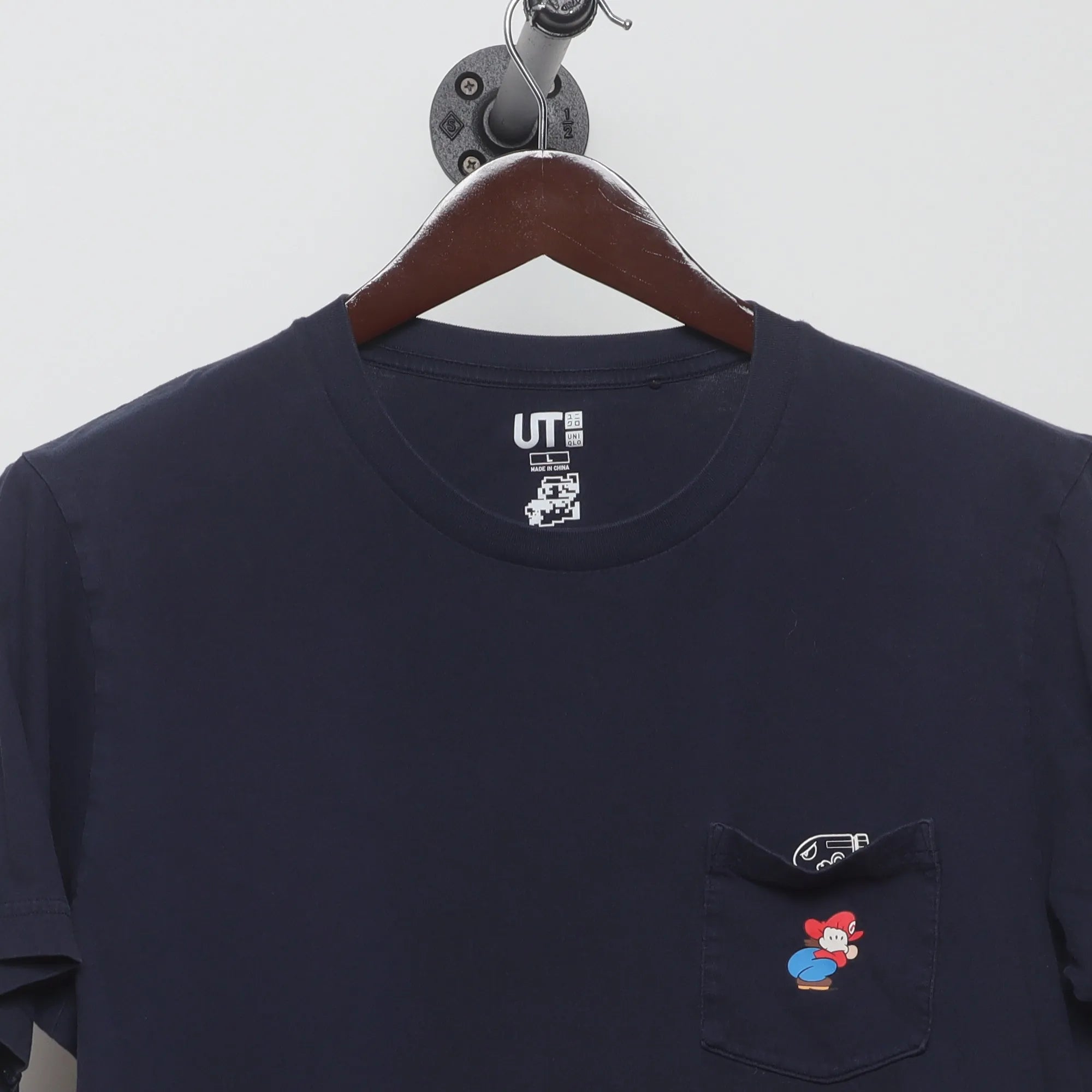 Close-up of the collar and tag on the Vintage 2010s Uniqlo Nintendo Mario Pocket T-Shirt L